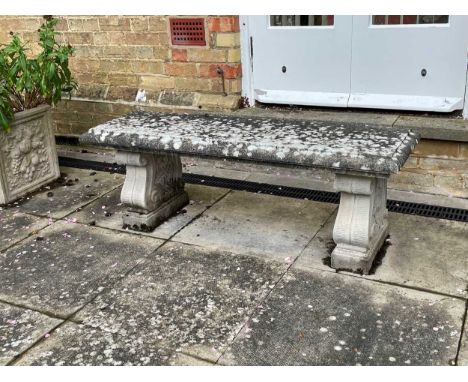 A scroll support reconstituted stone garden bench, 129cmin good condition with only minor knocks or losses, no sign of frost 