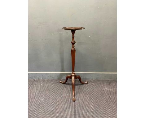 A George III style mahogany torchere stand, the octagonal top with a moulded chequered inlaid border, on a knopped and fluted