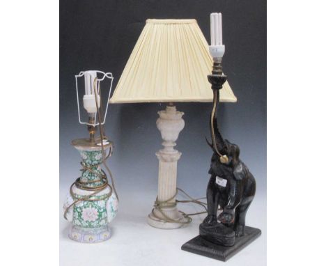 An alabaster table lamp, of column form with vase capital, chipped; an elephant base table lamp and a modern Chinese enamelle