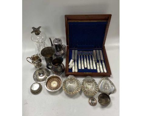 A collection of silverware including shell dishes, toast rack, candlesticks, salts, photo frame, ash trays, cream jug, silver