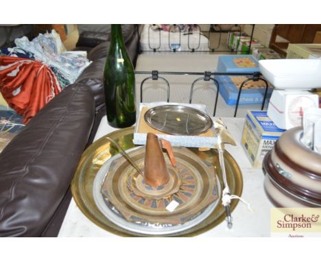 A quantity of Eastern brass trays; silver plated tray; a flag and green glass bottle