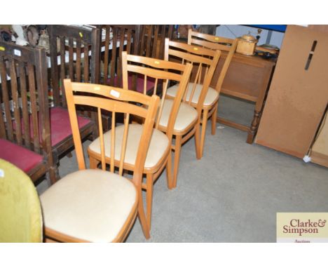 A set of four beech stick back dining chairs 