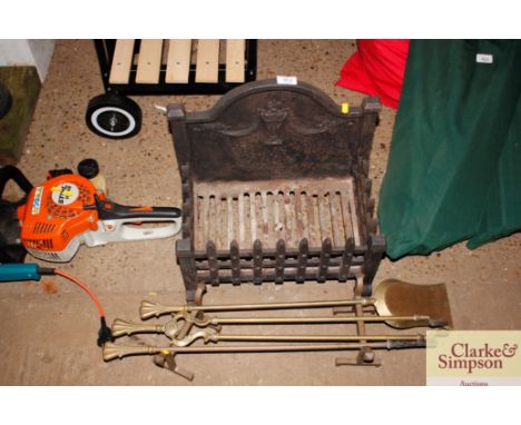 A fire grate together with a pair of brass fire dogs and irons