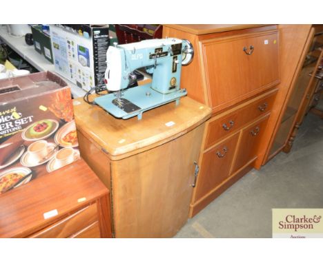 An Alfa electric sewing machine sold as collectors item with walnut cabinet 