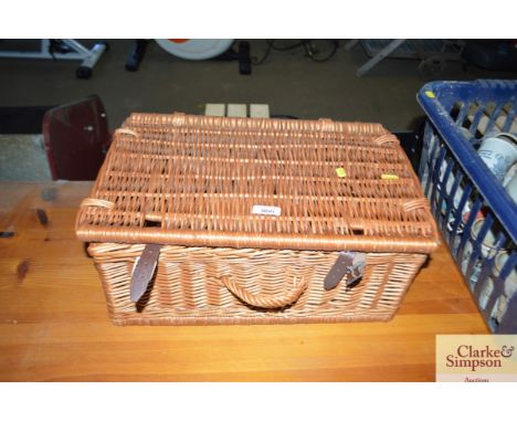 A wicker picnic hamper lacking contents 