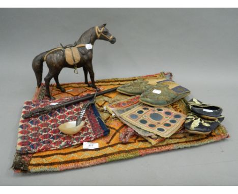 A collection of ethnographic items, including tapestry shoes, etc.