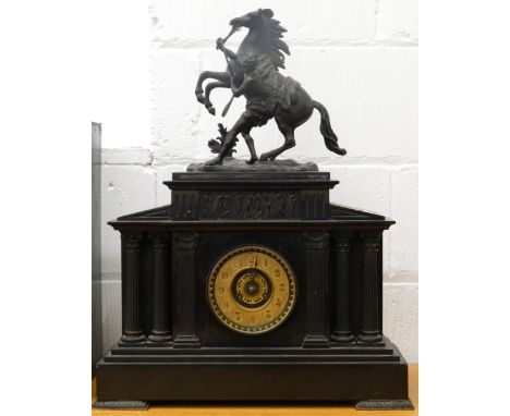 A Victorian black slate mantle clock surmounted with a Marley horse