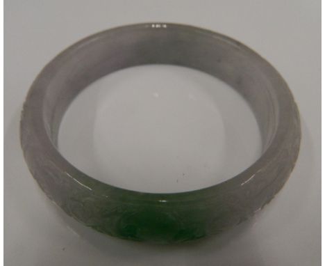 A carved jade bangle