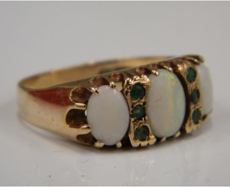 A 9 ct gold opal and emerald ring (3.8 grammes total weight)