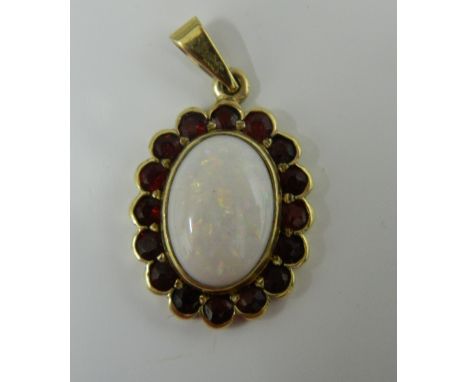 A 9 ct gold opal garnet pendant (3.5 grammes total weight)