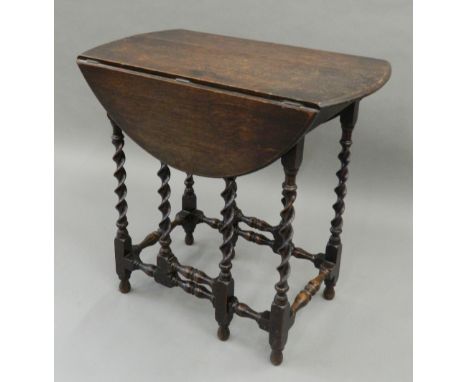 A small early 20th century oak barley twist gate leg table