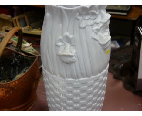 Plain white ceramic stickstand with miscellaneous contents