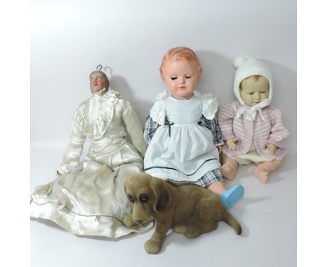A Belgian painted wooden marionette, with straw filled limbs, 60cm tall, together with two dolls and a nodding dog puppet 