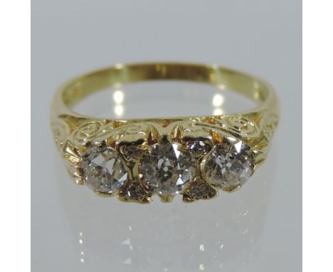An 18 carat gold three stone diamond ring, approx. 1.05 carat