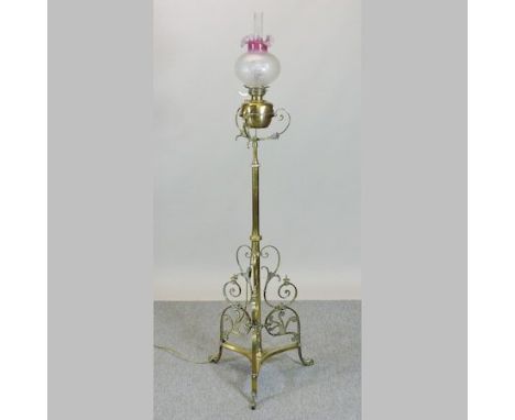 An ornate Victorian brass telescopic standard lamp, with an etched glass shade