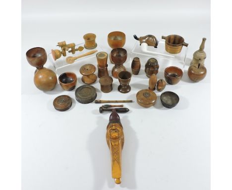 A collection of treen goblets and other items, to include a figural nutcracker, together with a carved panel, 44cm