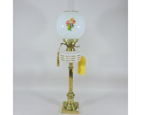 A Victorian brass Duplex oil lamp, with an opaque glass reservoir, and opaque shade, 77cm tall overall 