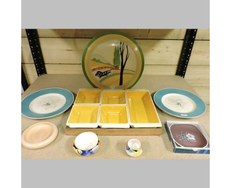 A Susie Cooper set of dishes on a wooden stand, together with a pair of plates, other dishes and a Wedgwood charger, 31cm