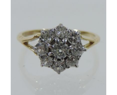 An 18 carat gold and diamond daisy ring, approx. 1 carat, boxed