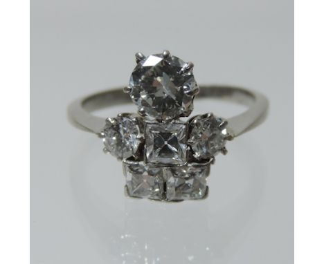 An early 20th century platinum and diamond dress ring, set with square and round cut diamonds, approx 1.5 carats overall