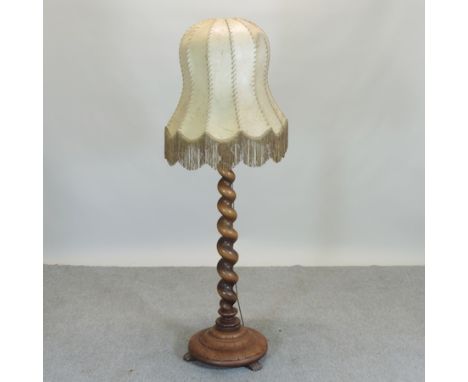 An early 20th century turned wooden standard lamp shade