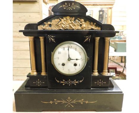 A Victorian black slate mantle clock, 38cm tall, together with and two German cuckoo clocks