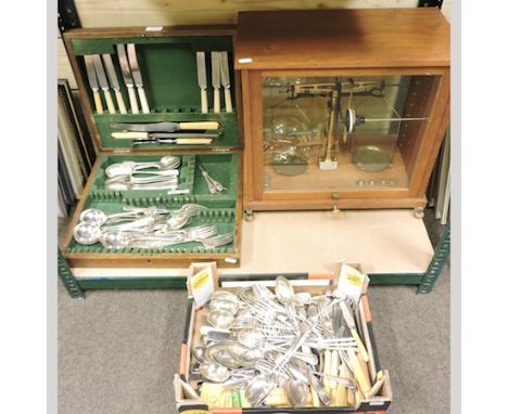 A set of 20th century balance scales by Baird and Tatlock, in a glass case, together with a collection of silver plated cutle