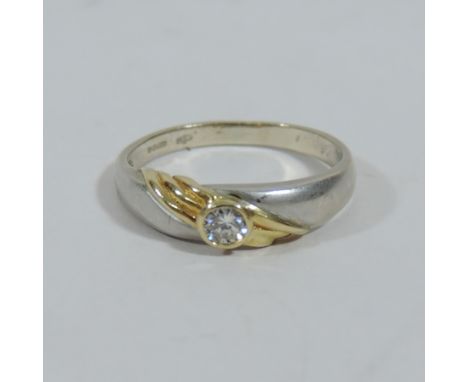 An 18 carat white and yellow gold single stone ring