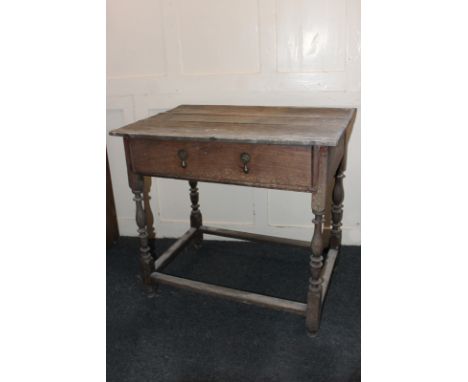 A 17th century rectangular oak side table with single drawer, teardrop handles, on turned supports and stretchers, 77cm, (NC)