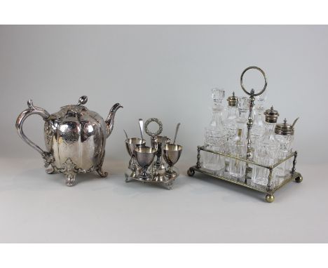 A silver plated cruet with six glass bottles, together with a Victorian silver plated teapot and an egg cup holder for four 