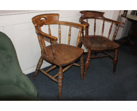 Two oak bow back tub shaped armchairs with turned supports and legs