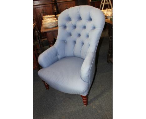 A small blue upholstered armchair with button back, on turned legs