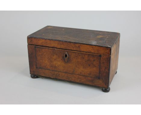 A walnut veneered tea caddy with inlaid ebony decoration (missing liners), 23cm wide