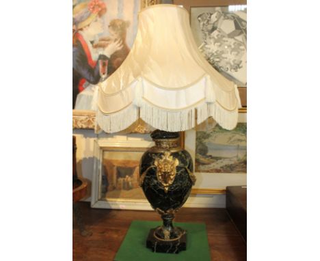 A black marble urn shaped table lamp with gilt ram heads and floral swag decoration, 55cm