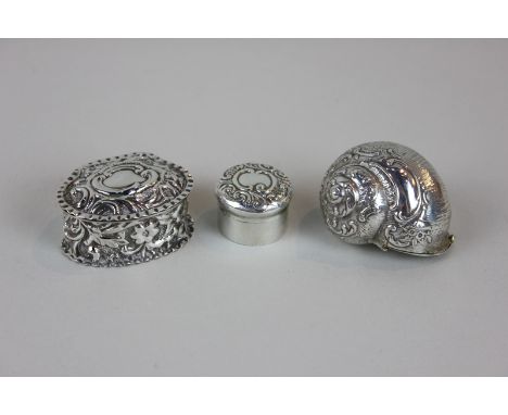Two Victorian silver pill pots, together with an unmarked silver coloured metal trinket box in the shape of a shell