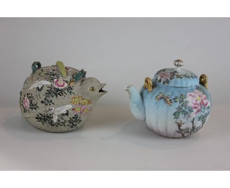 A Japanese pottery teapot modelled as a bird with raised painted decoration of storks and chrysanthemums, together with anoth