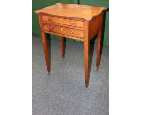 A mahogany side table with shaped top above two long drawers, on tapered legs on castors, 54cm