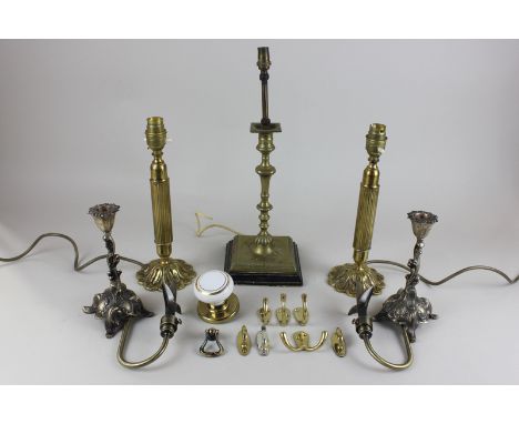 A pair of heavy Victorian silver plated candlesticks, together with a pair of brass column table lamps with floral shaped bas