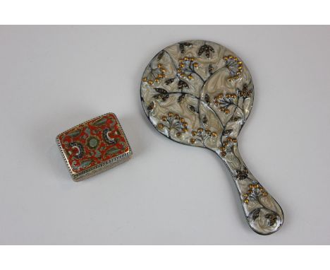 A small cloisonne trinket box with floral decoration containing four silver coins, together with an enamel and gem set hand m