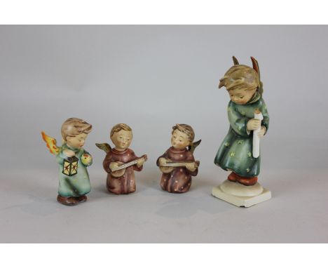 Four Goebel Hummel figures of angels playing instrument, carrying lights and candles, tallest 16cm