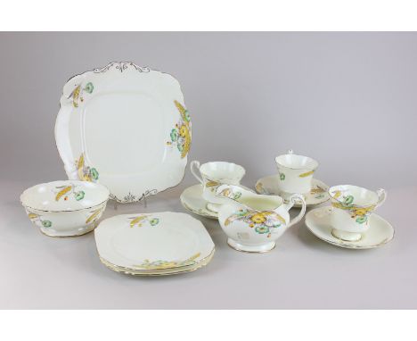 A Paragon tea set with twelve settings, cream ground with ears of corn and floral decoration and gilt embellishment, includin