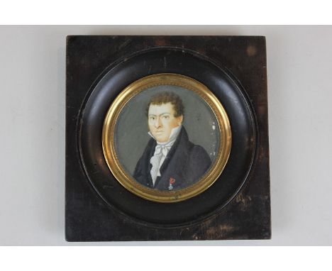 A 19th century circular miniature portrait of a gentleman, marked A Reichart to verso and R 1821 to front, oil on ivory (a/f 