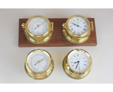 A brass FCC precision porthole clock and barometer mounted on wooden plinth, together with another matching set of a Kelvin H