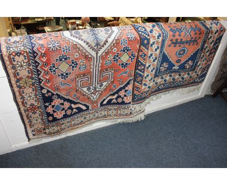 A Kilim rug with blue ground, rust and cream pattern around central motif, 128cm by 90cm, together with another runner carpet