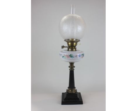 A glass and brass oil table lamp with globular frosted glass shade, 70cm tall