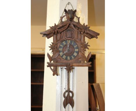 A Black Forest cuckoo clock decorated with foliage, the pinnacle modelled as a mounted stag's head (a/f)