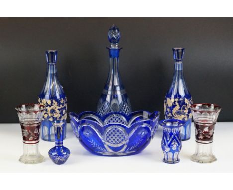 Glass Blue Flash Cut Decanter and Stopper, 37cm high together with a Pair of Blue Flash Cut Decanters with overlaid scrolling