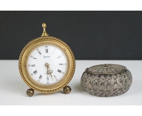 A vintage Swiza bedside clock with Roman numeral markers and brass case together with a white metal filigree box. 