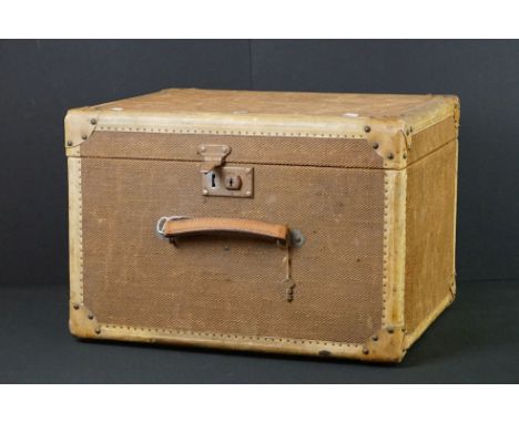 Early 20th Century fabric-covered travel trunk, of rectangular form, with leather carry handle, key and 'Golden Arrow' luggag