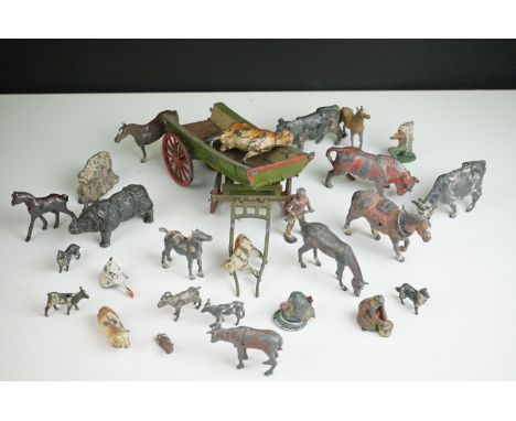 A small collection of vintage lead farm animals together with a cart. 